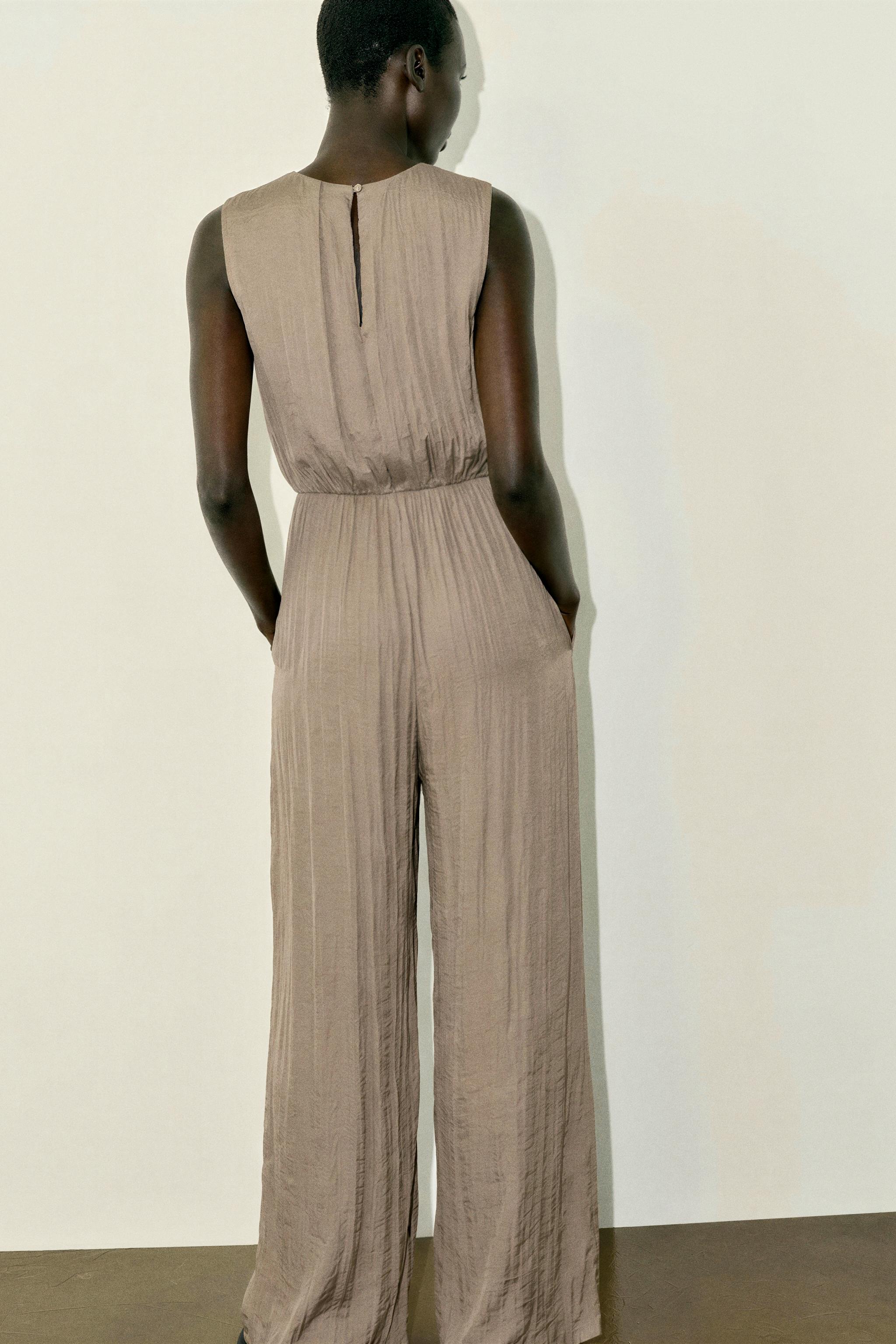 SATIN JUMPSUIT WITH SHOULDER FROG FASTENING